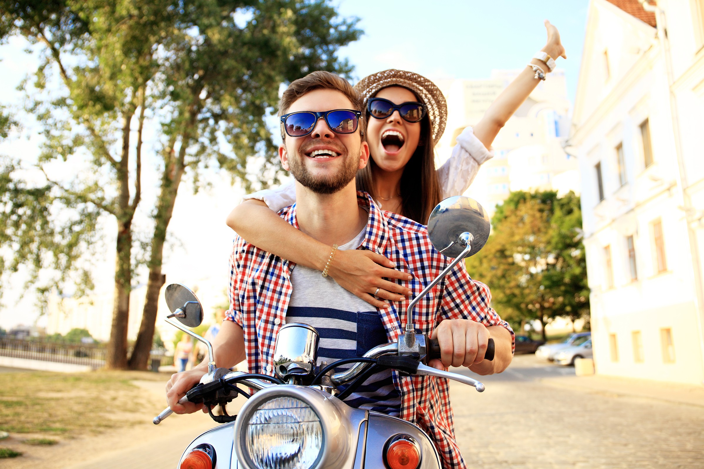 couple riding scooter having fun